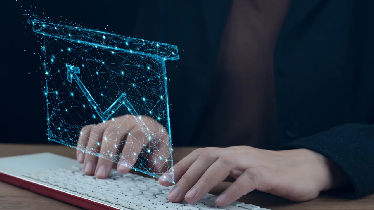 Digital email icon above hands typing on a keyboard.